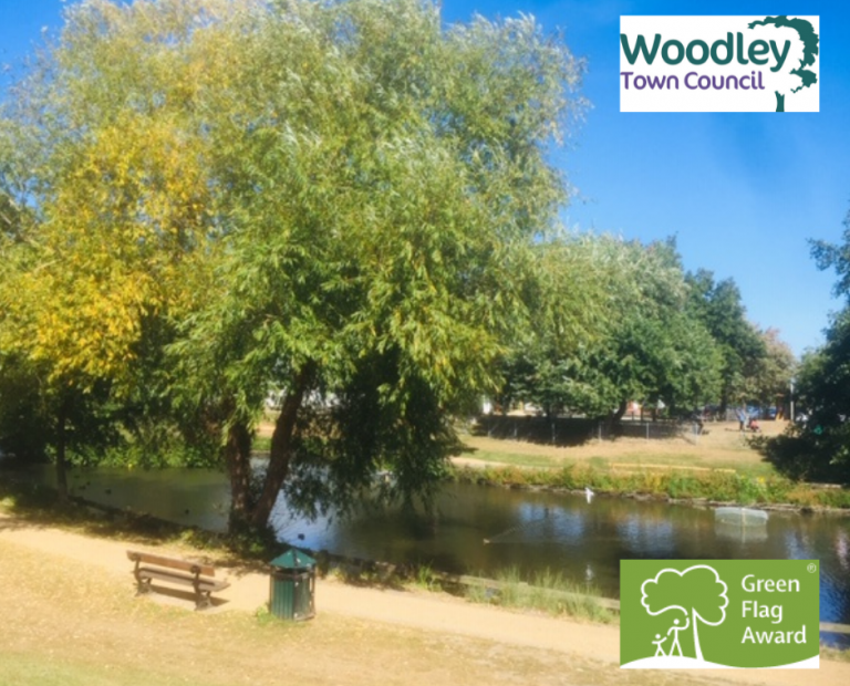 Image of the lake in Woodford Park with the Green Flag award logo