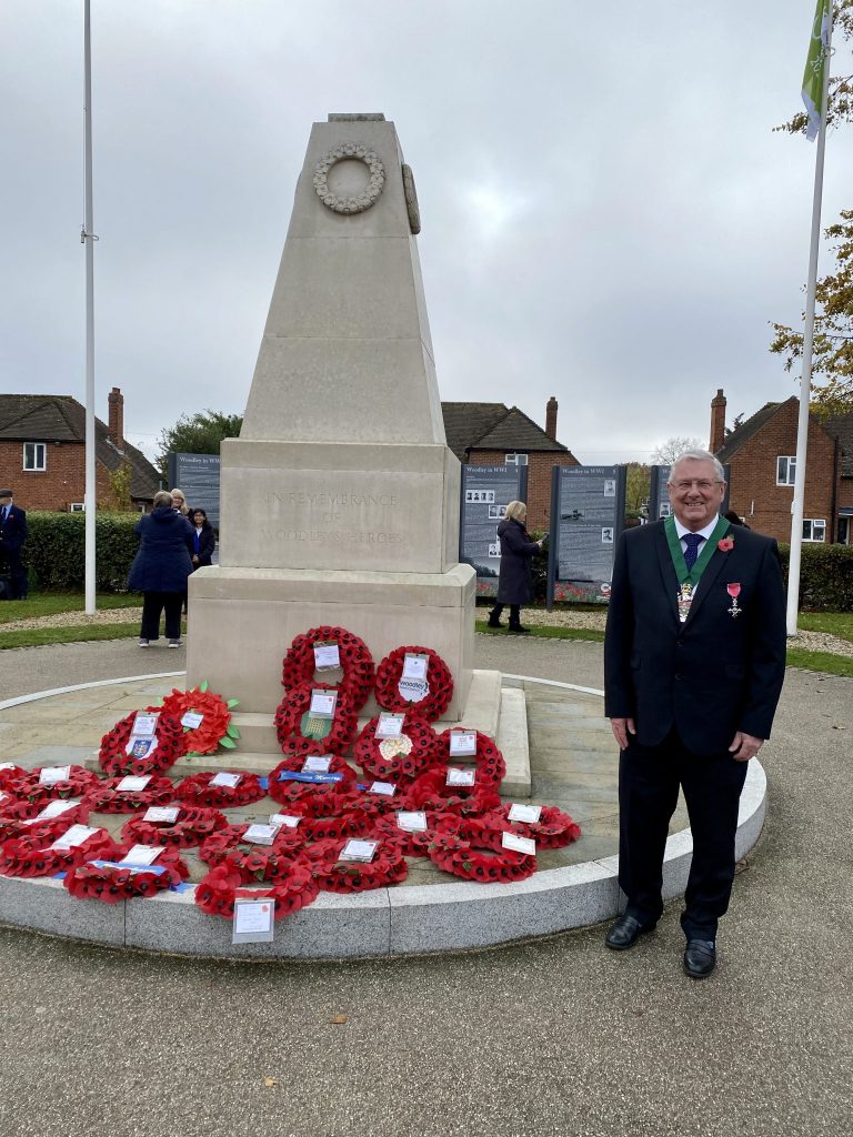 Councillor Keith Baker standing by Woodley War Memorial