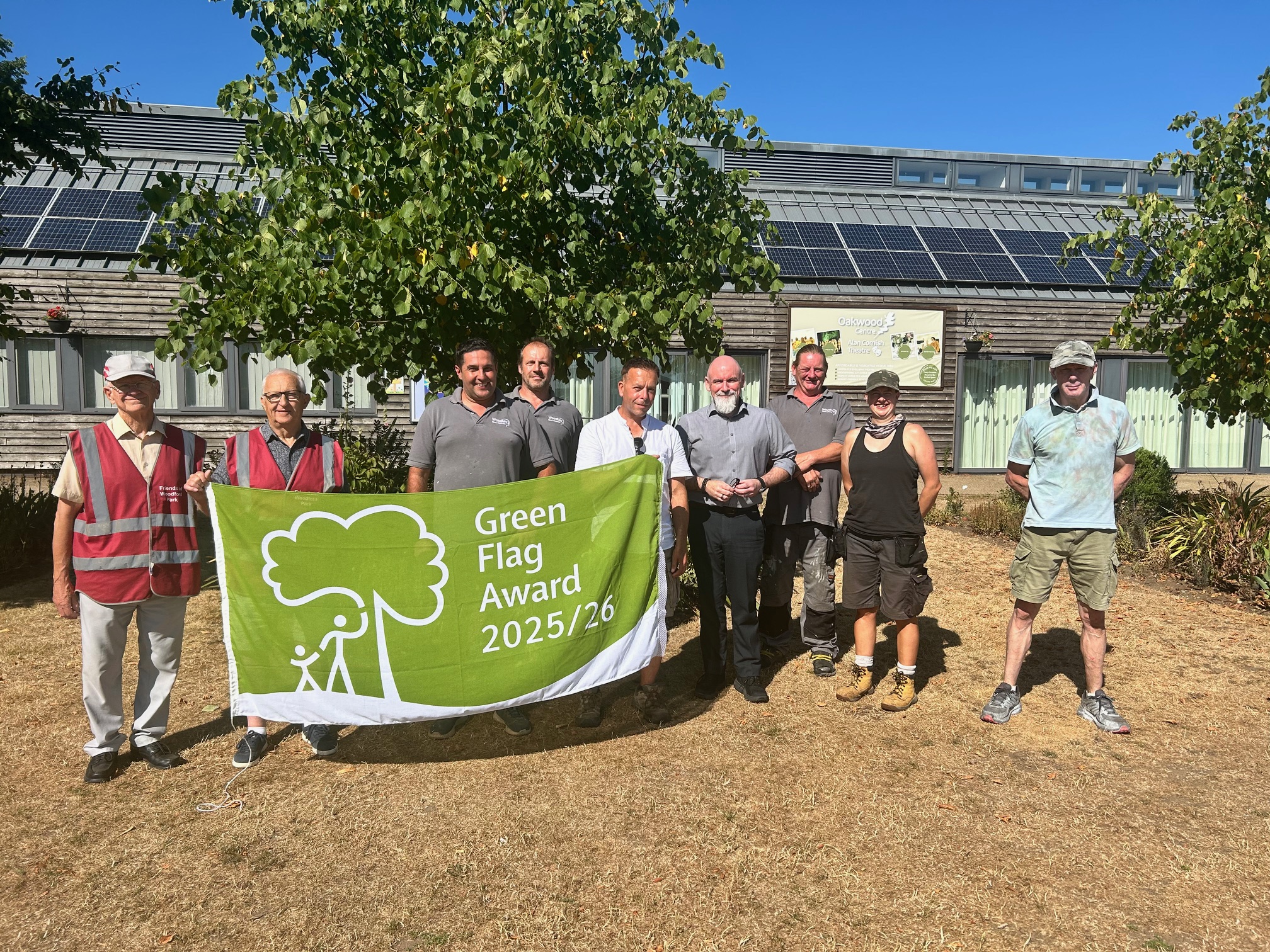 Photo of the Amenities Team and Friends of Woodford Park team members with the Green Flag Award
